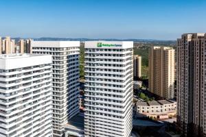 an aerial view of a tall building with a green roof at Holiday Inn Express Jincheng New District by IHG in Jincheng