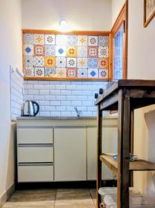 a kitchen with a sink and a counter top at ELLA CON El MAR in Mar del Plata