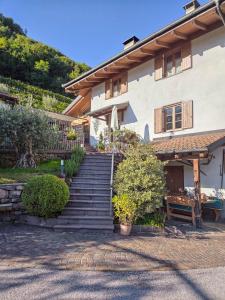 a house with stairs leading up to a building at Agriturismo ValFraja in Cembra