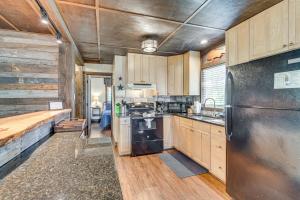 a kitchen with wooden cabinets and a stainless steel refrigerator at Waterside Anglers Heaven Crooked River Fish Camp in Yankeetown +16 photos