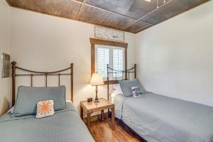 a bedroom with two beds and a table with a lamp at Waterside Anglers Heaven Crooked River Fish Camp in Yankeetown