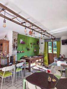 a dining room with green walls and tables and chairs at Agriturismo ValFraja in Cembra