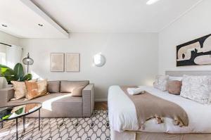 a living room with a bed and a couch at On Park - Century City Lux Studio Apartment in Cape Town