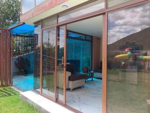 a glass extension of a house with a pool at Lejaim1 in Hacienda Capulí