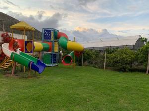 a playground with a slide in the grass at Lejaim 