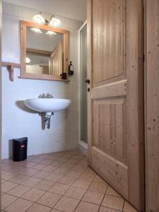 a bathroom with a sink and a mirror and a door at Agriturismo ValFraja in Cembra +134 photos