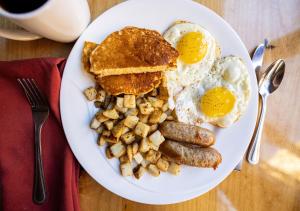 a plate of breakfast food with eggs sausage and toast at Zion Lodge - Inside the Park in Springdale +18 photos