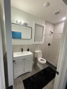 a bathroom with a sink and a toilet and a shower at Cozy Short Stay in Newark