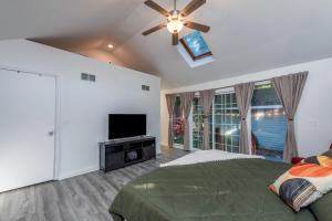 a bedroom with a bed and a flat screen tv at Cottingham Cottage in Zion