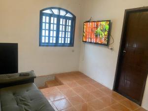 a living room with a couch and a window at Casa Pôr do Sol Angra in Angra dos Reis