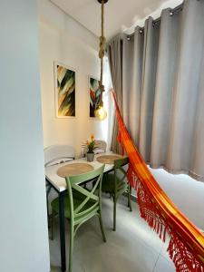 a dining room with two tables and chairs at Flat completo a 50m do mar do Bessa - até 4 pessoas in João Pessoa +10 photos