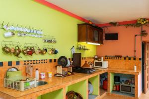 a kitchen with green and orange walls and a counter at DAR Moha dades in Aït Ougliff +58 photos
