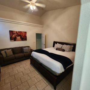 a bedroom with a large bed and a couch at The Gathering Spot-6 miles from Sequoia Nlt'l Park in Three Rivers +7 photos