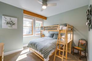 a bedroom with a bunk bed with a ladder at Mtn Views and Spacious Deck! Modern Caldwell Getaway in Caldwell