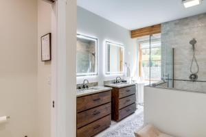 a bathroom with two sinks and a shower at Mtn Views and Spacious Deck! Modern Caldwell Getaway in Caldwell +29 photos