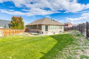 a house with a fence and a yard at Work and Play in Aurora Spacious Home with Yard! in Altura