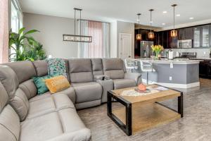 a living room with a couch and a table at Work and Play in Aurora Spacious Home with Yard! in Altura