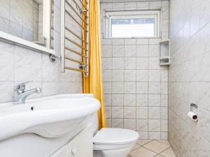 a bathroom with a white toilet and a sink at 6 person holiday home in Augustenborg in Augustenborg