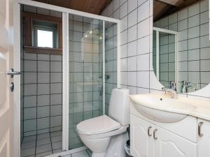 a bathroom with a toilet and a sink and a shower at 4 person holiday home in Egå in Egå +18 photos