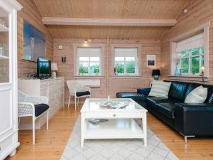 a living room with a couch and a table at 4 person holiday home in Egå in Egå