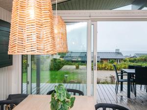 a dining room with a table and a large window at 6 person holiday home in Rønde-By Traum in Rønde +23 photos