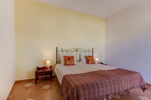 a bedroom with a bed and two pillows on it at Villa Damara in Albox +22 photos