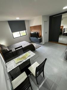a bedroom with a bed and a table and chairs at Flat Novissimo ,100M mar , praia Intermares, acomoda ate 4 pessoas in Cabedelo