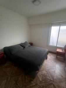 a bedroom with a bed and a window at Playa 81 in Necochea