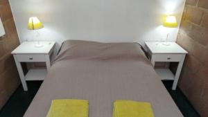 a bedroom with two nightstands and a bed with two lamps at Monoambiente Para 2 in Belén