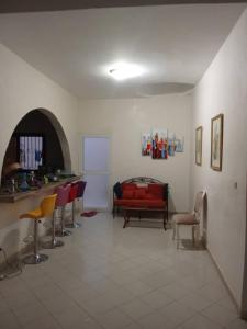 a living room with a red couch and chairs at Villa NINA in Yof