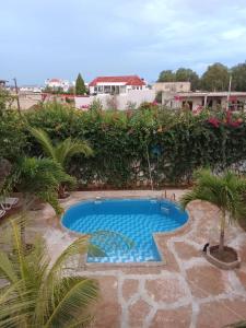 a swimming pool in the middle of a yard at Villa NINA in Yof