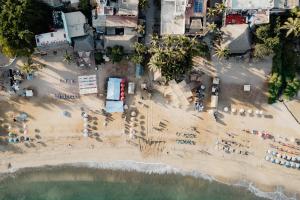 an aerial view of a beach with umbrellas and chairs at Villa Alhelí | Ocean View 3BR w/ Private Pool, Steps to Beach – Sayulita in Sayulita