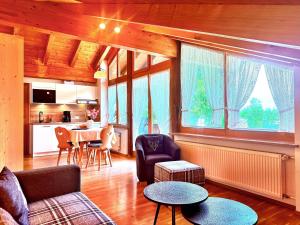 a living room with a couch and a table at Haus am Balsberg in Unterwössen