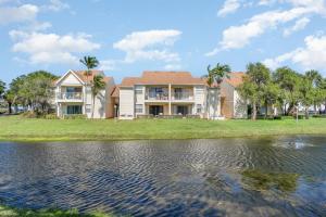 a house on the shore of a body of water at Serene Zen King Bed Condo - Half Mile from Beach in Melbourne