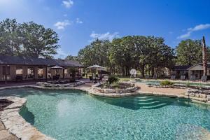 a swimming pool in the middle of a yard at Ranch | 4 Homes | Pool | Sleeps 40 in Luling