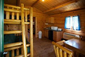 Cabaña de madera con litera y cocina en Fremont RV Campground Cottage 28, en Fremont