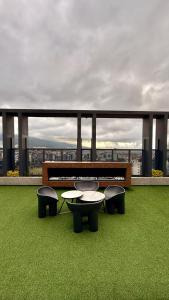 a balcony with tables and chairs on a building at Lujosas suites XOE in Quito
