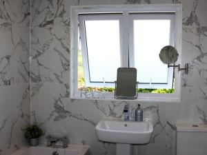 a bathroom with a sink and a window at 3 bed in Gorran Haven 83495 in Gorran Haven +22 photos