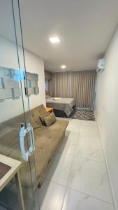 a living room with a couch and a bed at Flat aconchegante 1307 in Fortaleza