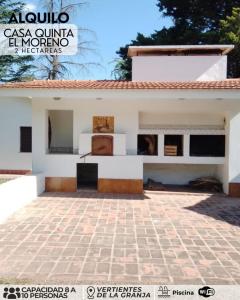 a house with a stone patio in front of it at El morenito in La Granja