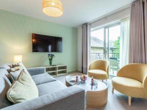 a living room with a couch and chairs and a tv at 2 Bed in St. Mellion 87708 in St Mellion