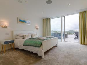 a bedroom with a bed and a large window at 5 Bed in Polruan 77657 in Polruan +18 photos