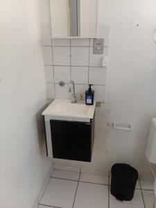 a small bathroom with a sink and a toilet at Apartmento Itanhaem in Itanhaém +6 photos