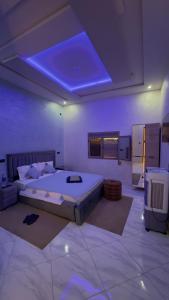a bedroom with a large bed with a blue ceiling at Riad Mifis in Rissani
