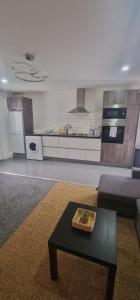 a living room with a table and a kitchen at Private Mini House, 5 min to City, Hotel linen in Cardiff