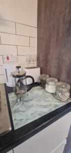 a counter top with jars and bowls on it at Private Mini House, 5 min to City, Hotel linen in Cardiff