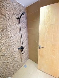a shower with a glass door in a bathroom at Endless Wave Surf Camp in Agadir