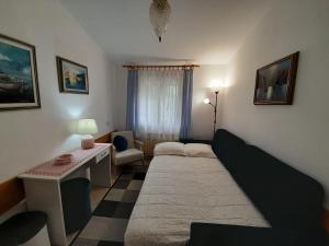 a small living room with a bed and a couch at Apartments by the sea Novigrad - 7335 in Novigrad Istria
