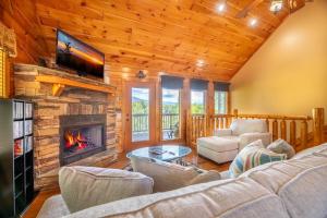 a living room with a couch and a fireplace at Simply Heaven in the Smokies By Avada Properties in Wear Valley