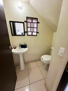 a bathroom with a sink and a toilet at Steps to the sand with Balcony and Ocean View in Rosarito Beach +11 photos